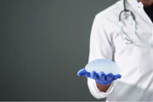 Silicone breast implant in the hands of a doctor.