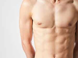 Male torso showing a flat, toned chest after gynecomastia surgery.
