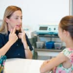 Speech therapist helping a child with cleft palate care